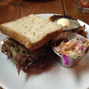 Pulled duck sandwich and johnnycakes